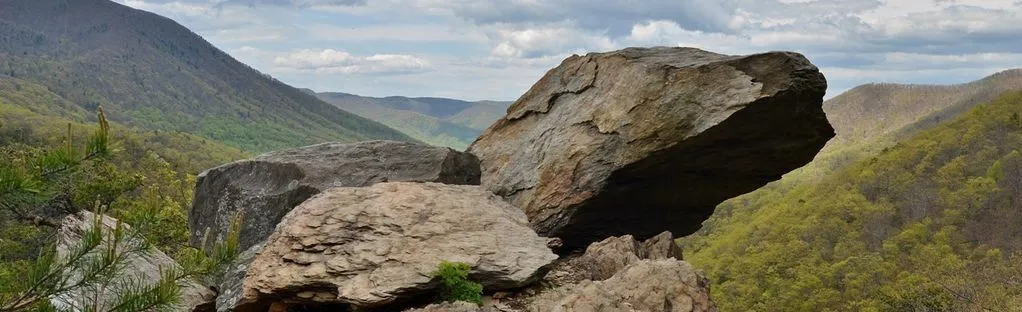 A rocky overlook on the Appalachian Trail with the Blue Ridge spreading out below.